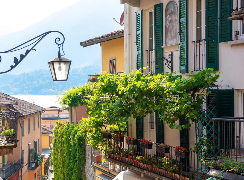 Bellagio street with colourful buildings, green shutters and lake view
