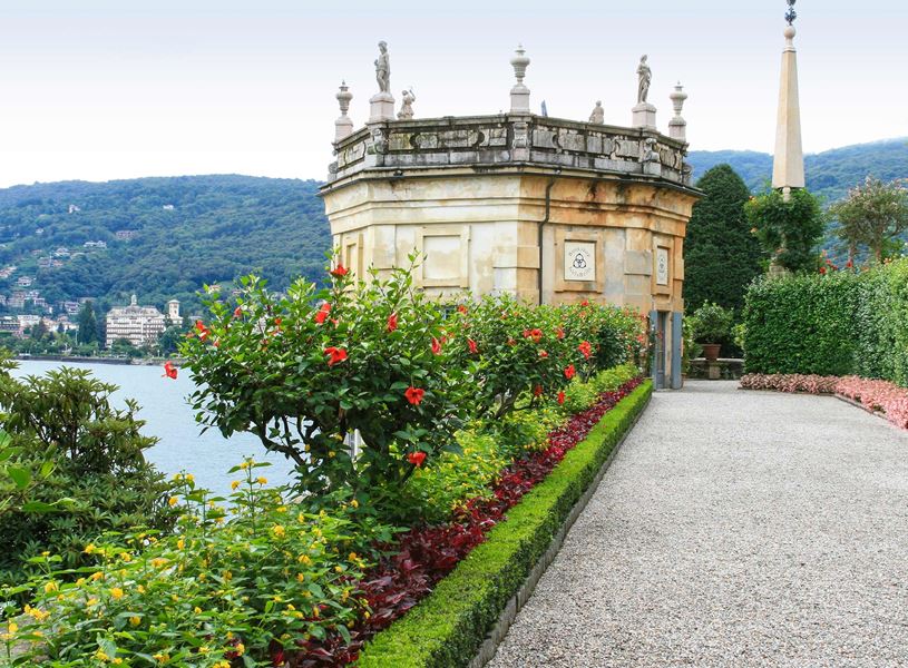 Borromeo Palace Garden with flower-lined path overlooking lake and mountains