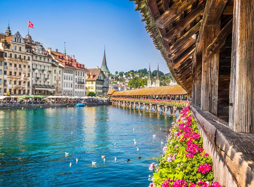 Flower-lined Chapel Bridge over Reuss River in Lucerne, Switzerland