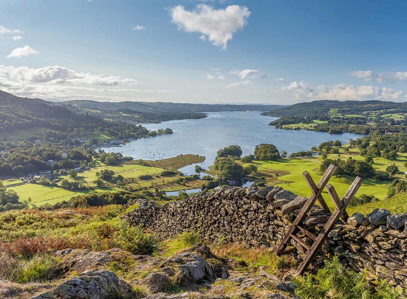 Lake District landscape with stone wall, ladder and scenic lake view in England