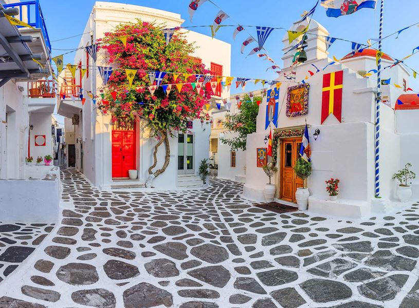 Picturesque street with vibrant flowers and whitewashed buildings, Mykonos, Greece