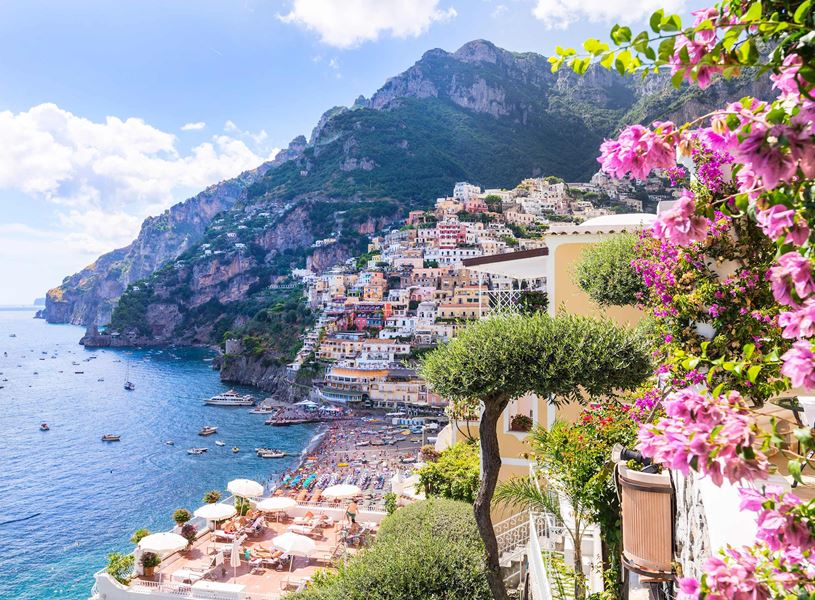Positano on the Amalfi Coast with colourful houses and pink flowers