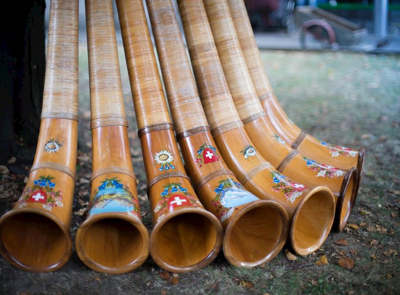 Traditional Swiss alphorns decorated with floral and flag motifs