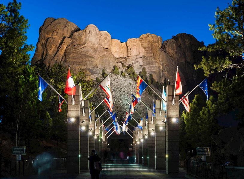Mount Rushmore illuminated during the evening lighting ceremony, South Dakota, USA