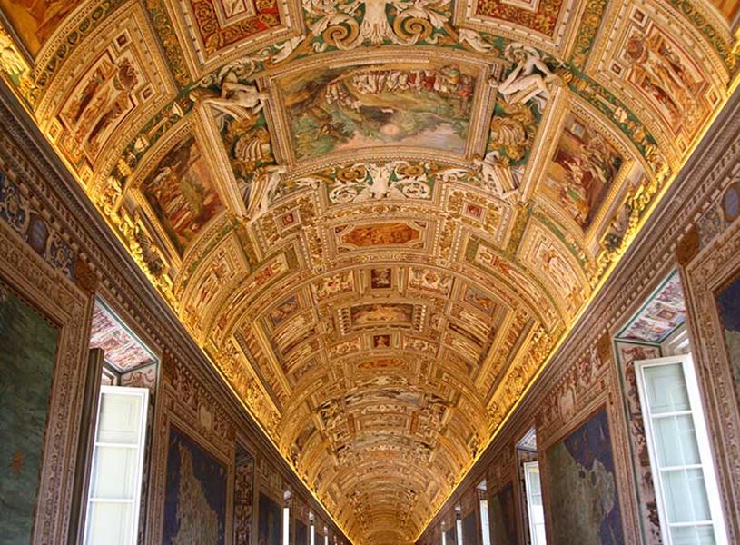 Vaulted ceiling in Gallery of Maps at Vatican Museums with detailed frescoes and gilded decorations