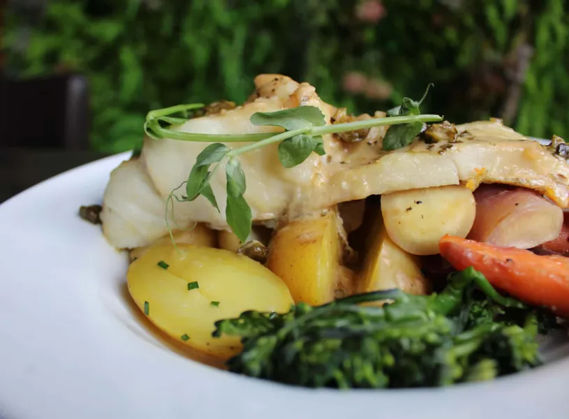 Pan-seared fish fillet served with baby potatoes, carrots and greens at Mharsanta restaurant, Glasgow